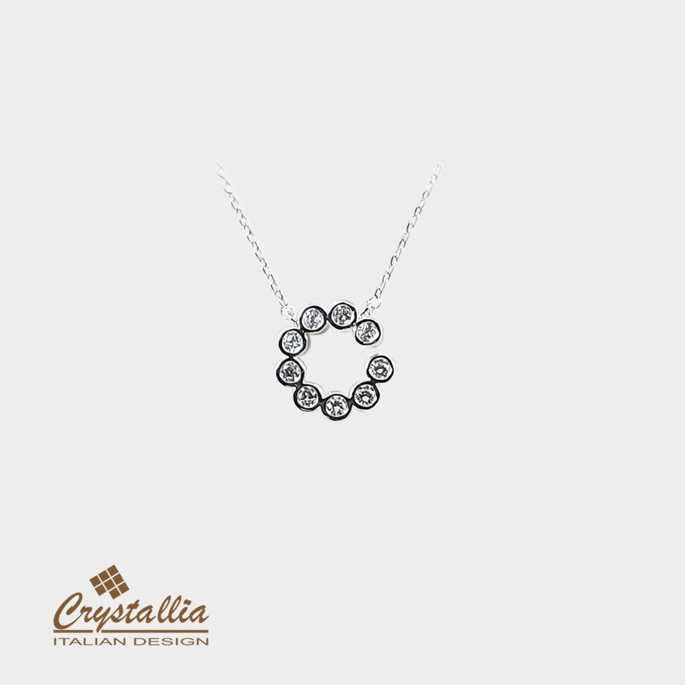 Silver necklace with a circular pendant on a white background, featuring the Crystallia brand.