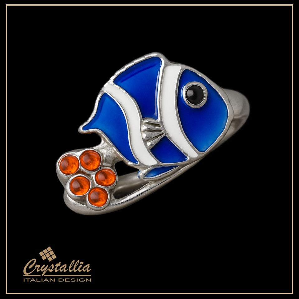 Blue fish-shaped ring with orange accents on a black background, featuring the Crystallia brand.
