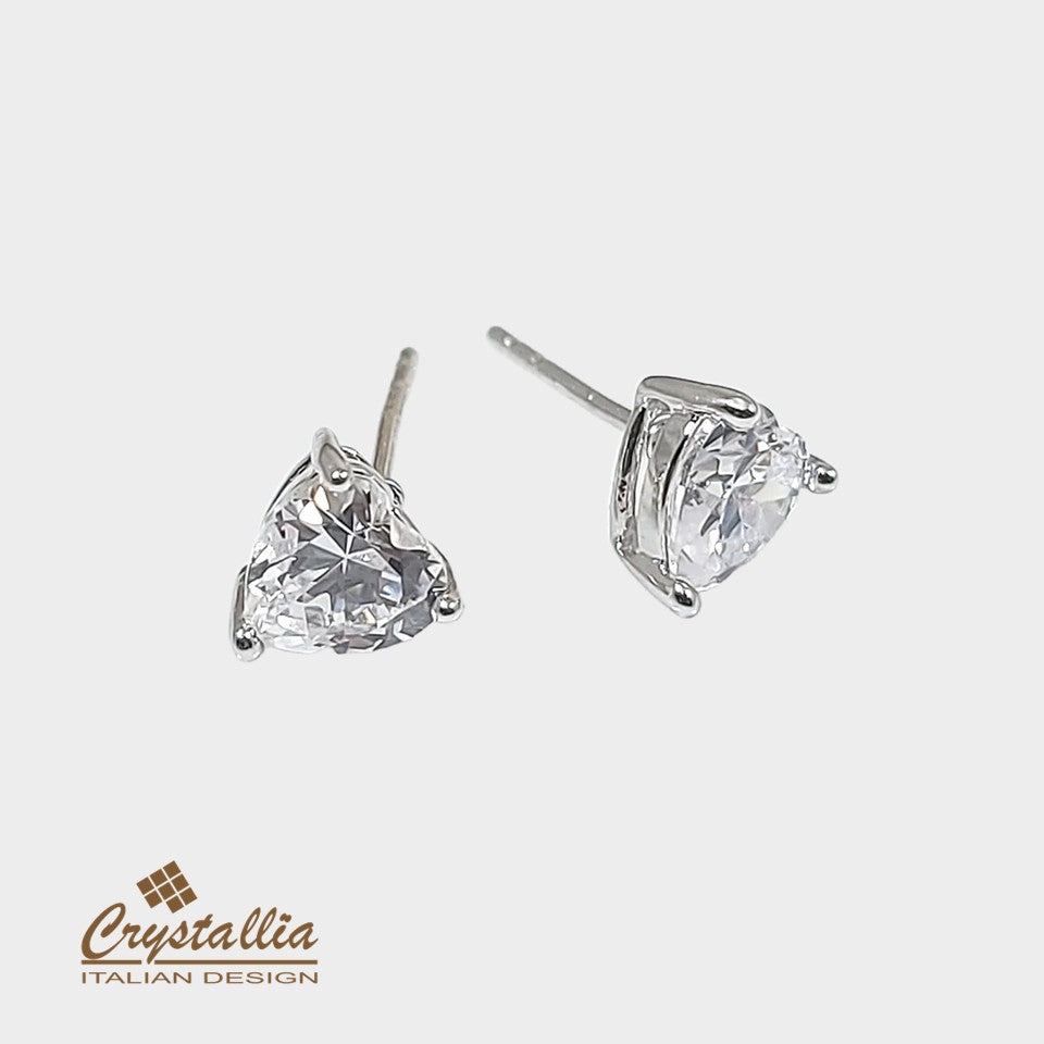 Pair of heart-shaped crystal earrings on a white background with Crystallia logo.