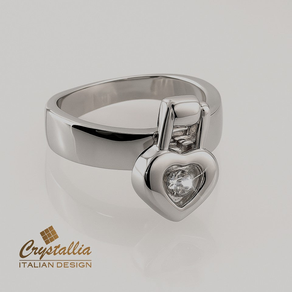 Silver ring with heart-shaped gemstone on a light gray background, featuring Crystallia brand.