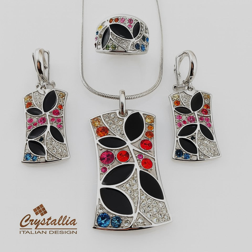 Jewelry set with pendant, ring, and earrings featuring colorful gemstones on a white background. Crystallia brand visible.