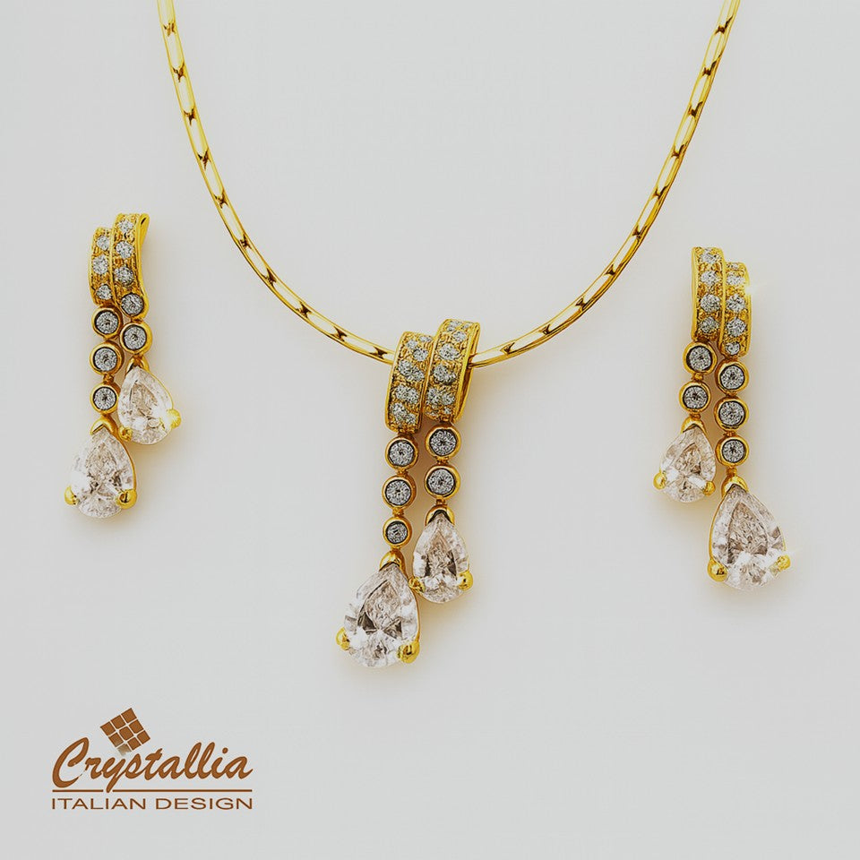 Gold jewelry set with Crystallia branding on a light gray background