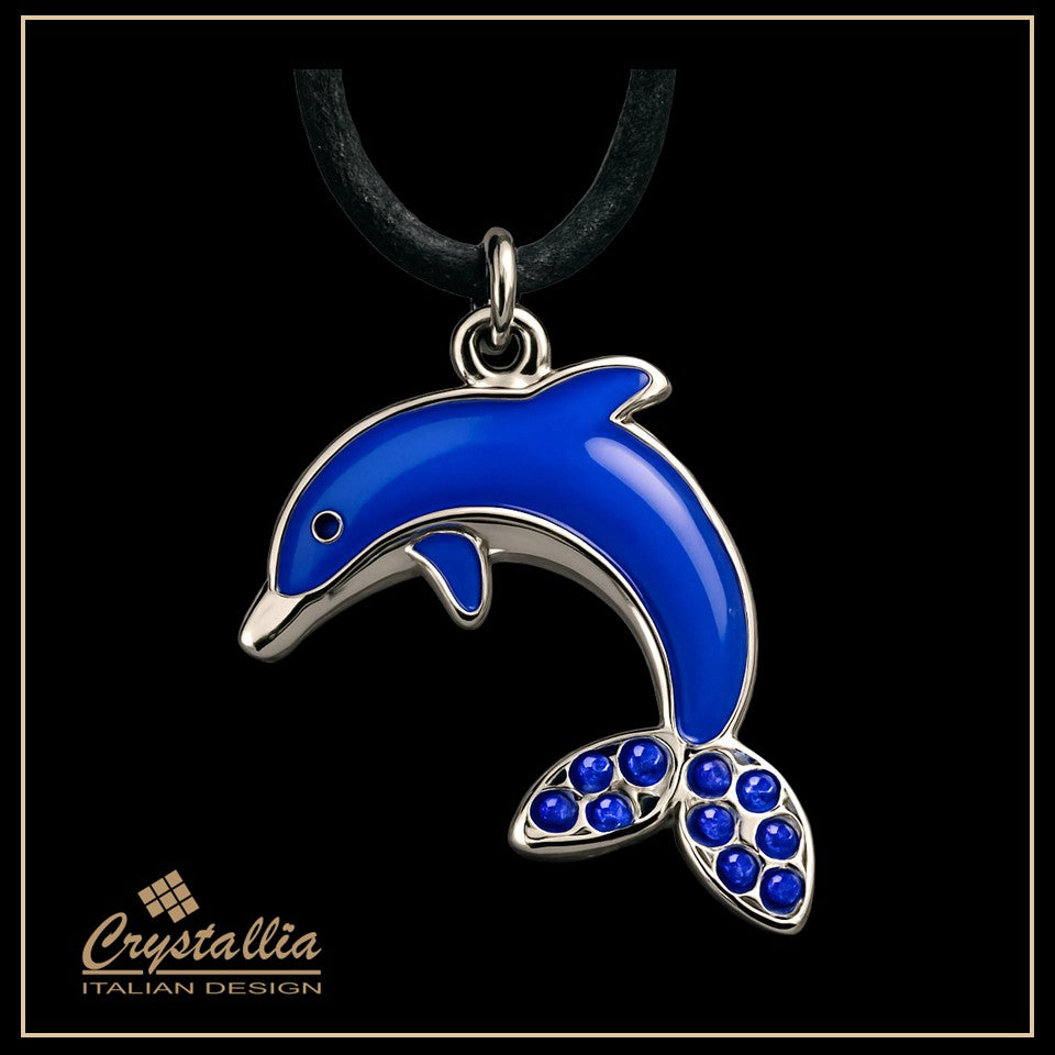 Blue dolphin pendant with silver accents on a black background, featuring the Crystallia brand.