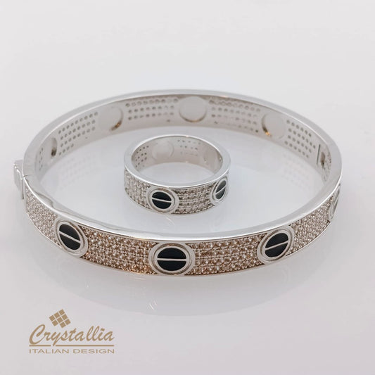 Silver bracelet with black stones on a white background, featuring the Crystallia brand.