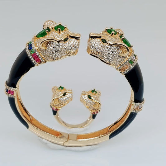 Luxury bracelet with panther design and gemstones on a light gray background