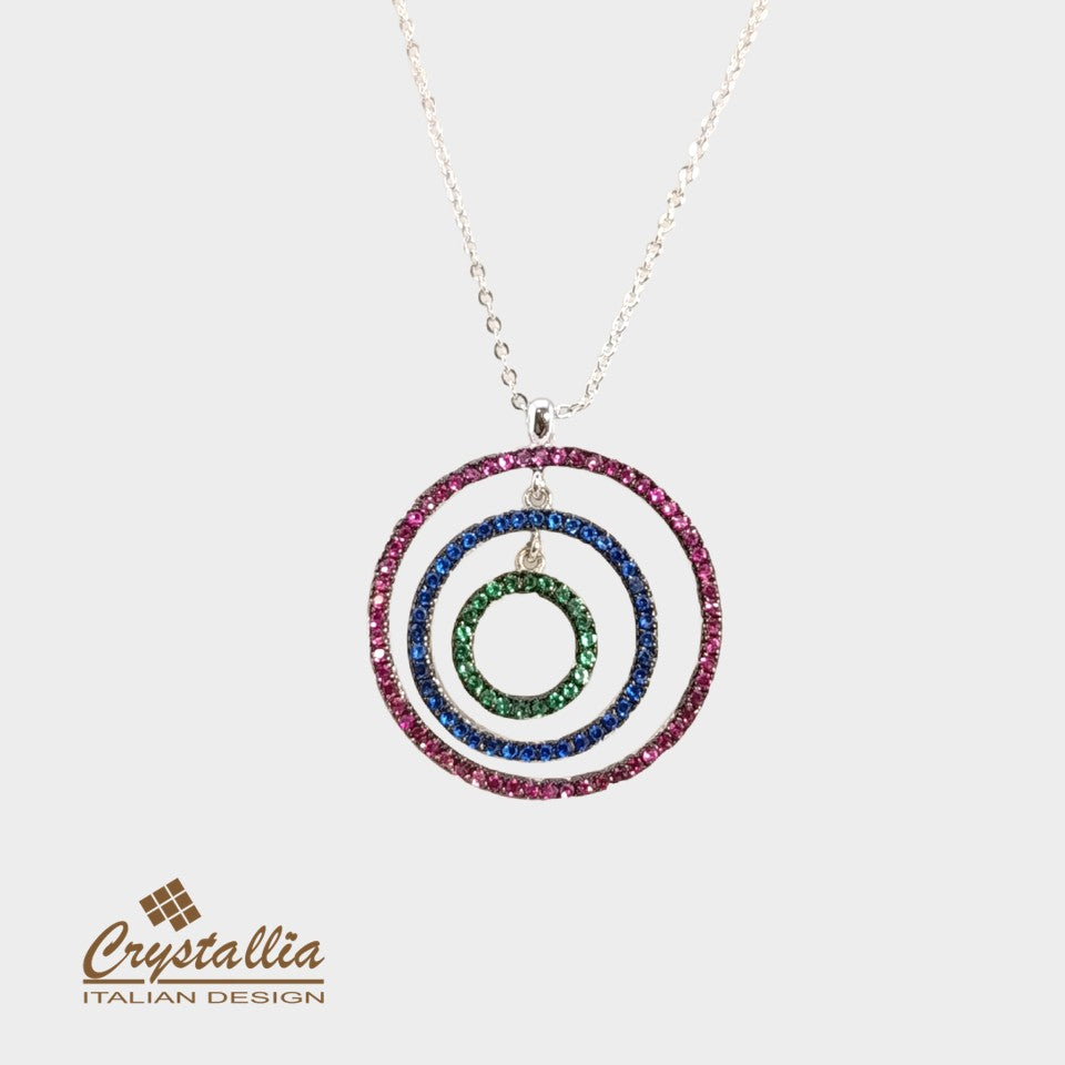 Necklace with circular pendant featuring colored stones on a white background, branded 'Crystallia'.