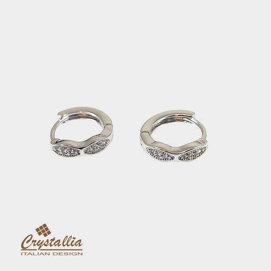 Pair of silver hoop earrings with Crystallia logo on a white background