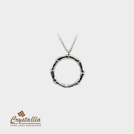 Silver necklace with a circular pendant on a white background, featuring the Crystallia brand.