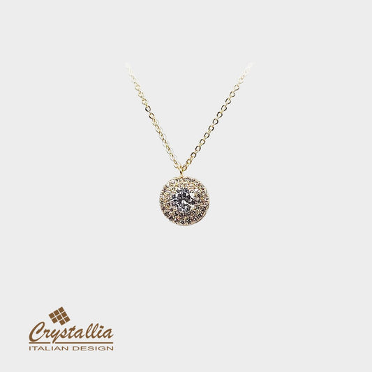 Gold necklace with a diamond pendant on a white background, featuring the Crystallia brand.