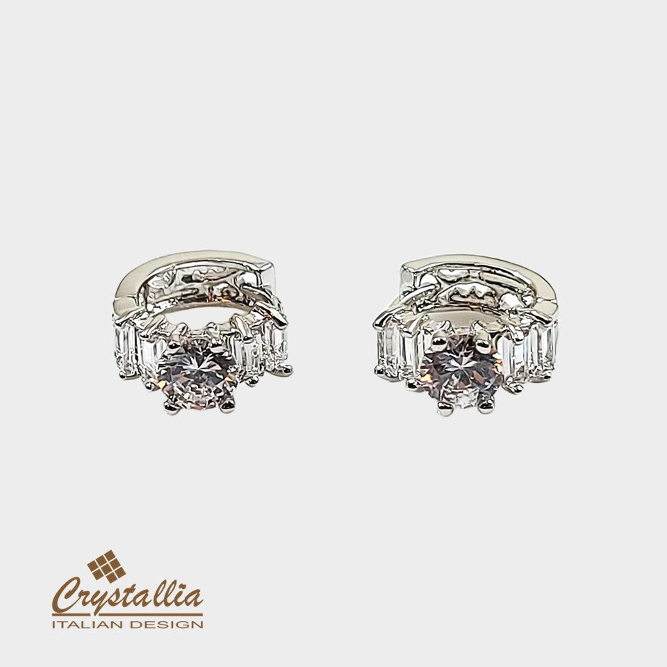 Pair of diamond earrings with 'Crystallia' branding on a white background