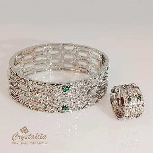 Silver bracelet and ring with green gemstones on a white background, featuring the Crystallia brand.