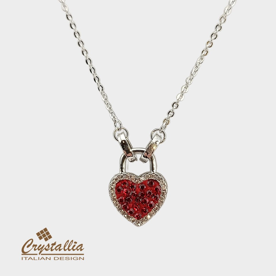 Heart-shaped pendant with red stones on a silver chain, branded 'Crystallia'.