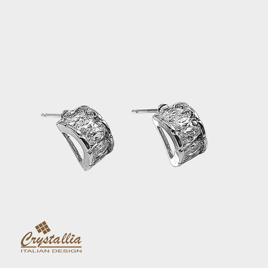 Pair of silver hoop earrings with 'Crystallia' logo on a light gray background