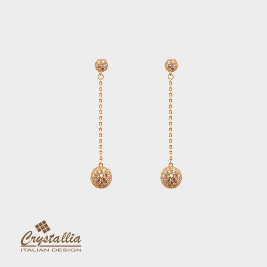 Gold earrings with Crystallia logo on a light background