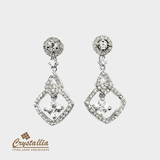 Pair of silver earrings with clear gemstones on a white background, featuring the Crystallia brand.
