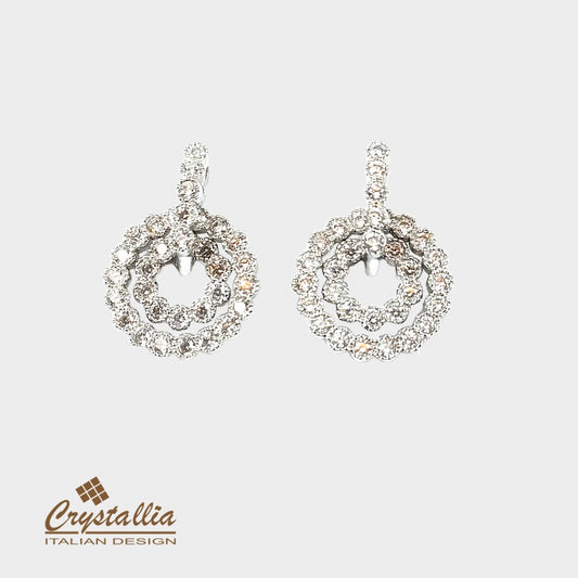 Pair of silver earrings with Crystallia logo on a light gray background