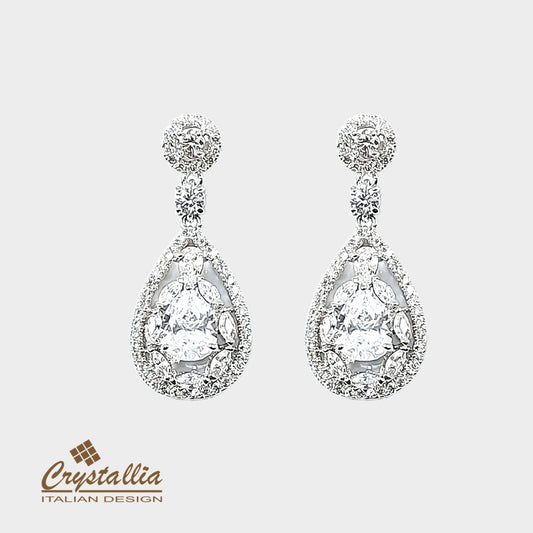 Teardrop-shaped crystal earrings on a light gray background with Crystallia logo.