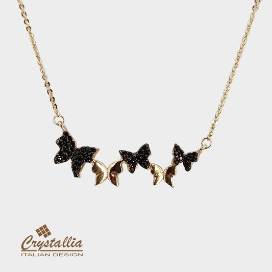 Necklace with butterfly-shaped black stones on a gold chain, branded 'Crystallia'.