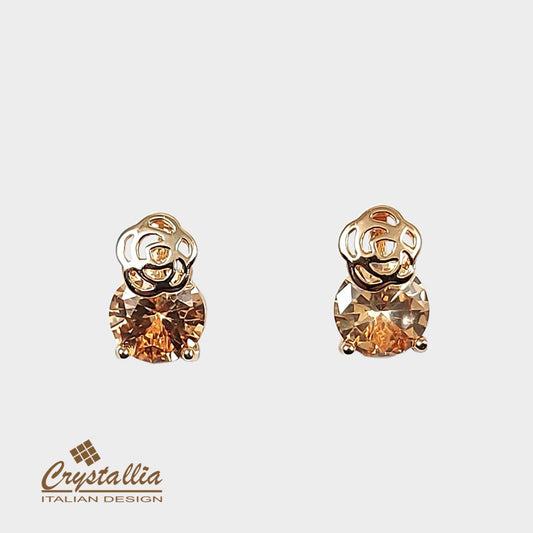 Gold earrings with brown gemstones on a light gray background, featuring the Crystallia brand.
