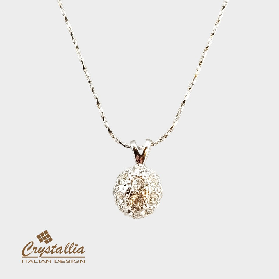 Gold necklace with intricate design on a white background, featuring the Crystallia brand.