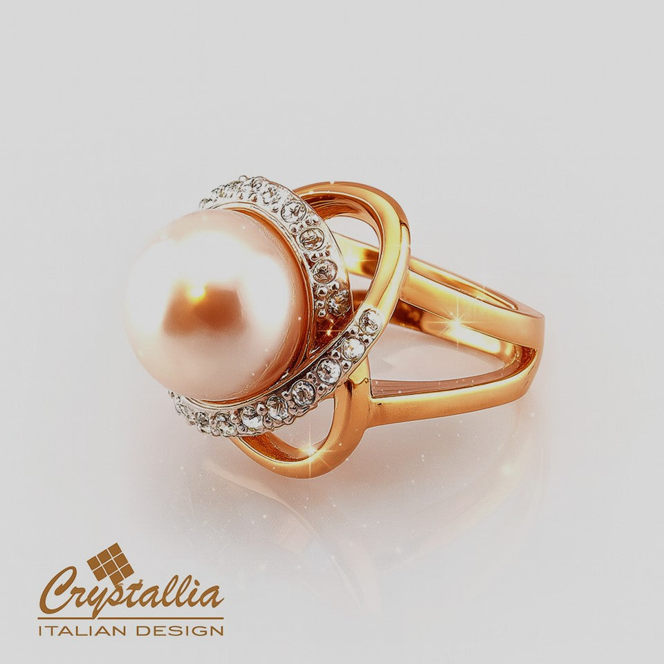 Gold ring with a pearl and crystals on a light background, featuring the Crystallia brand.