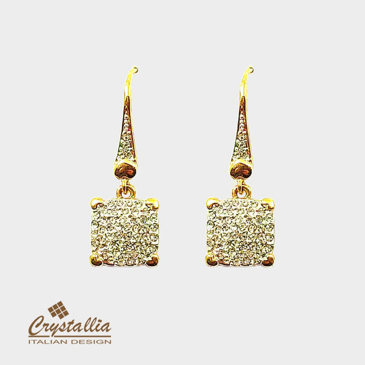 Gold earrings with diamond-like stones on a white background, featuring the Crystallia brand.