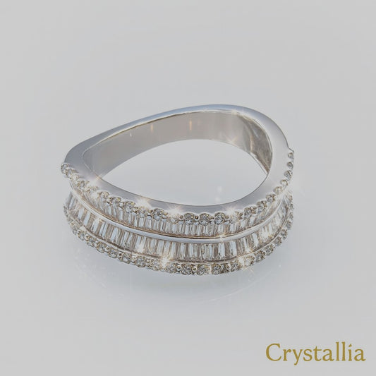 Stack of silver rings with diamond accents on a light gray background, branded 'Crystallia'.