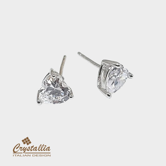 Pair of heart-shaped crystal earrings on a white background with Crystallia logo.