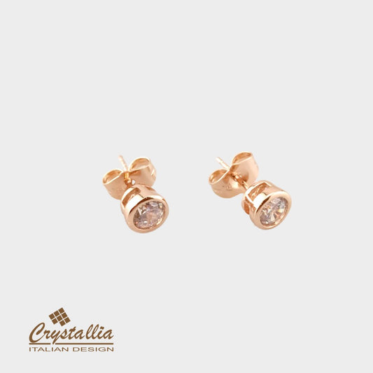 Rose gold stud earrings with Crystallia logo on a light gray background