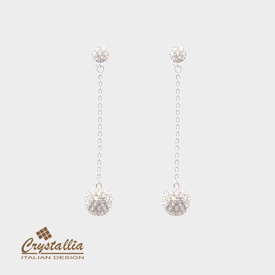 Pair of silver earrings with Crystallia logo on a light gray background
