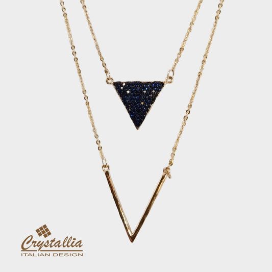 Necklace with a triangle pendant and gold chain on a light background, featuring the Crystallia brand.