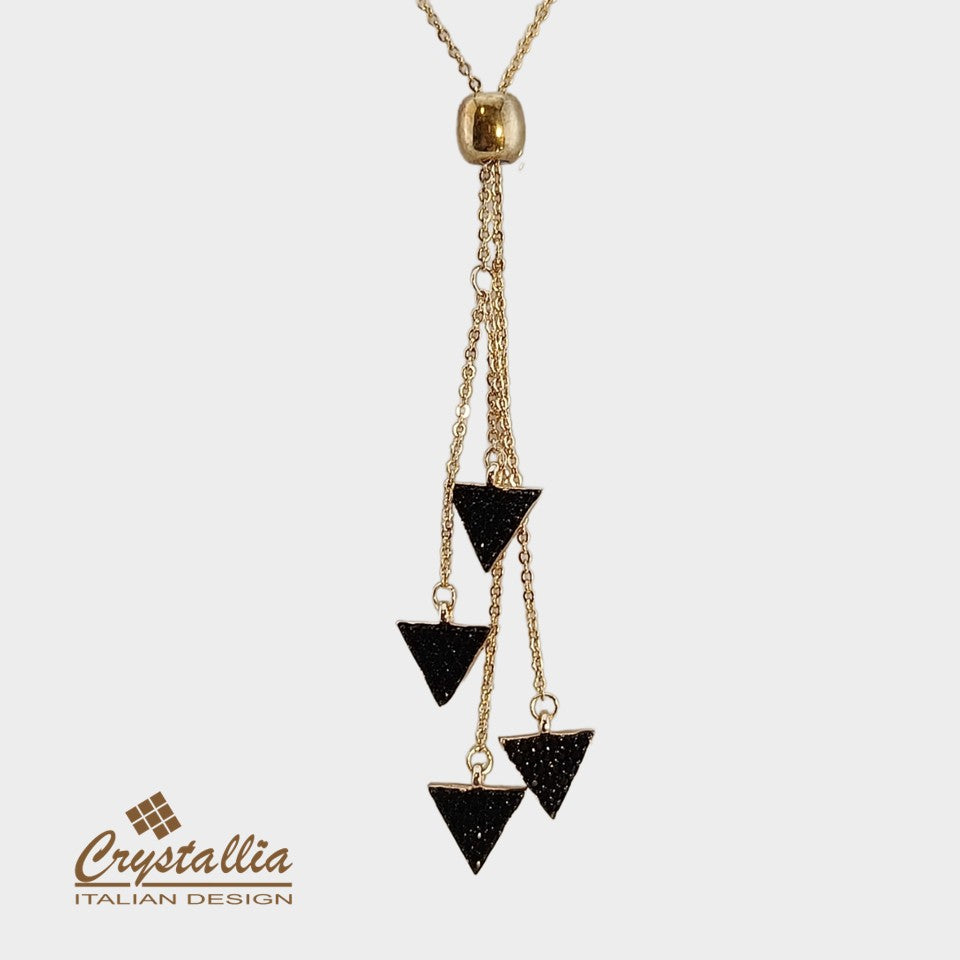 Gold necklace with black triangle pendants on a white background, featuring the Crystallia brand.