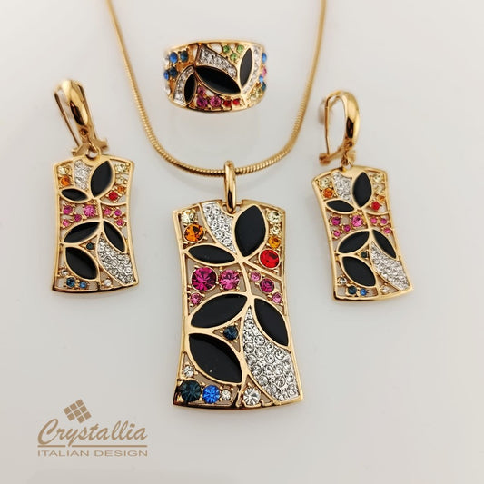 Jewelry set with pendants, earrings, and a ring on a light background, featuring the Crystallia brand.