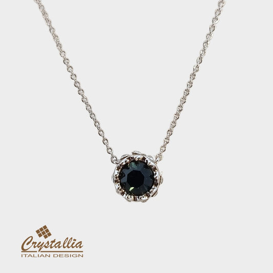 Necklace with a black gemstone pendant on a white background, featuring the Crystallia brand.