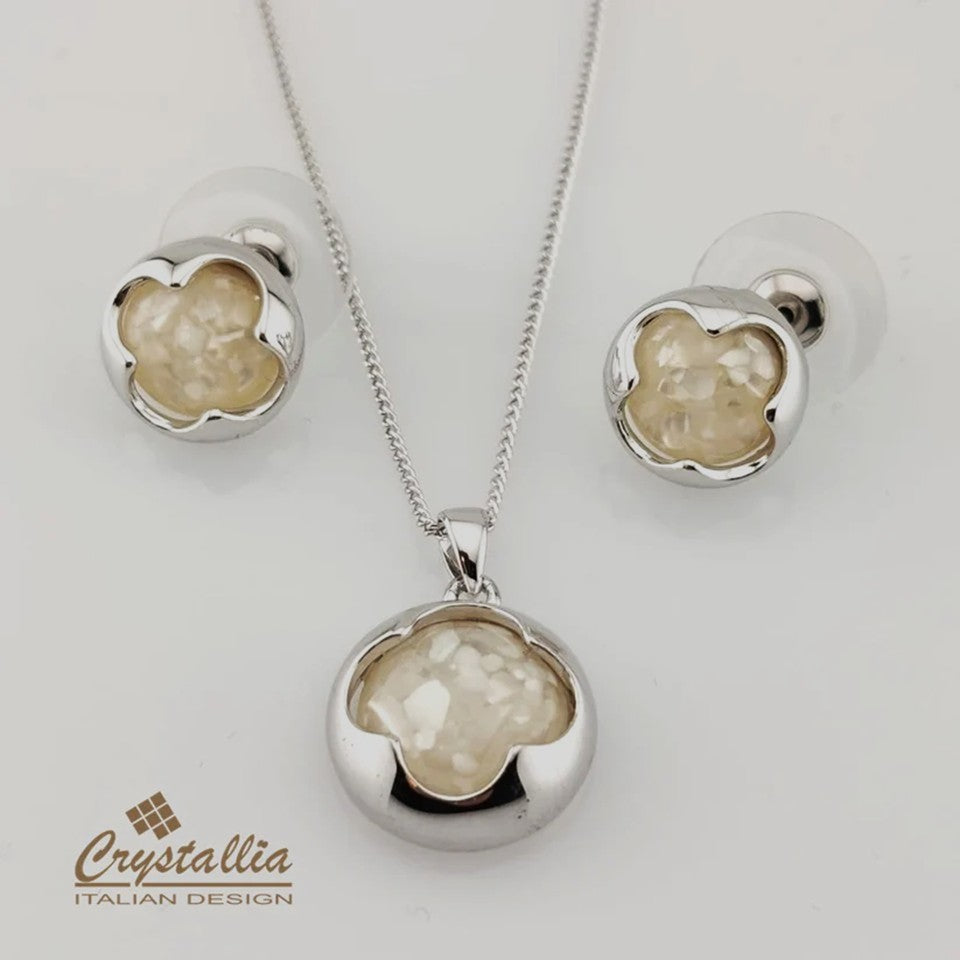 Jewelry set with pendant and earrings on a white background, featuring the Crystallia brand.