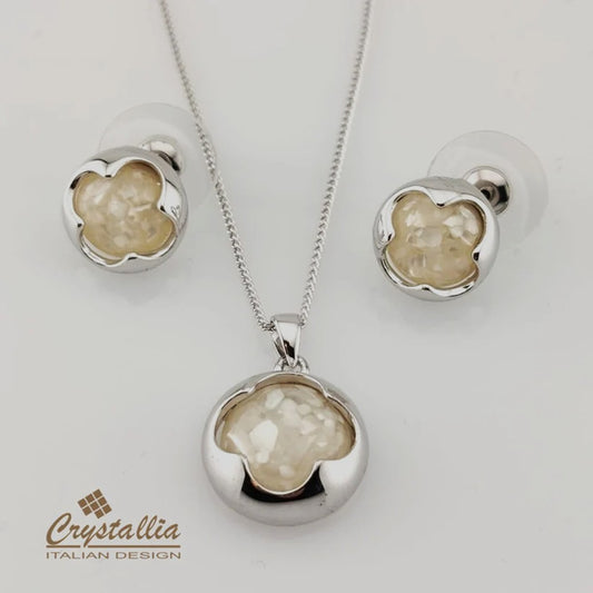 Jewelry set with pendant and earrings on a white background, featuring the Crystallia brand.