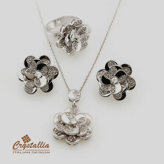 Jewelry set with floral designs including a necklace, ring, and earrings on a white background with 'Crystallia' branding.
