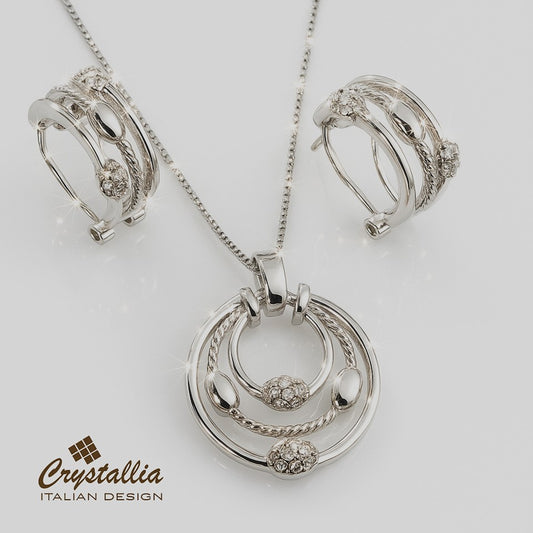 Silver jewelry set with pendant, earrings, and brooch on a white background, featuring the Crystallia brand.