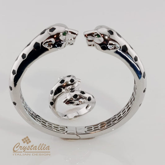 Silver bracelet with panther designs on a white background, featuring the Crystallia brand.