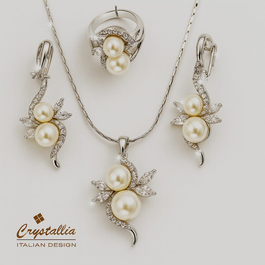 Pearl jewelry set with necklace, earrings, and ring on a white background, featuring the Crystallia brand.