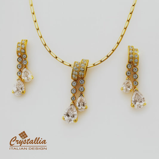 Gold jewelry set with Crystallia branding on a light gray background