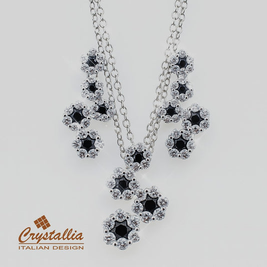Jewelry set with black and clear stones on a white background, featuring the Crystallia brand.