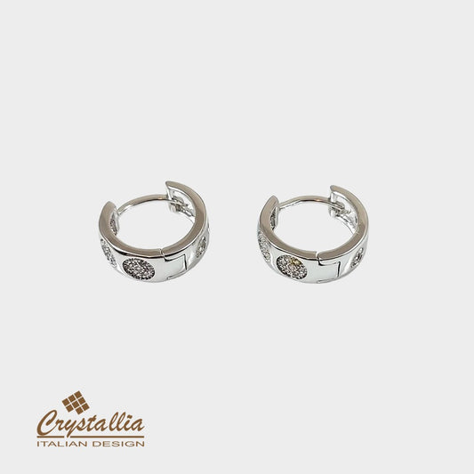 Silver hoop earrings with embedded stones on a white background, featuring the Crystallia brand.