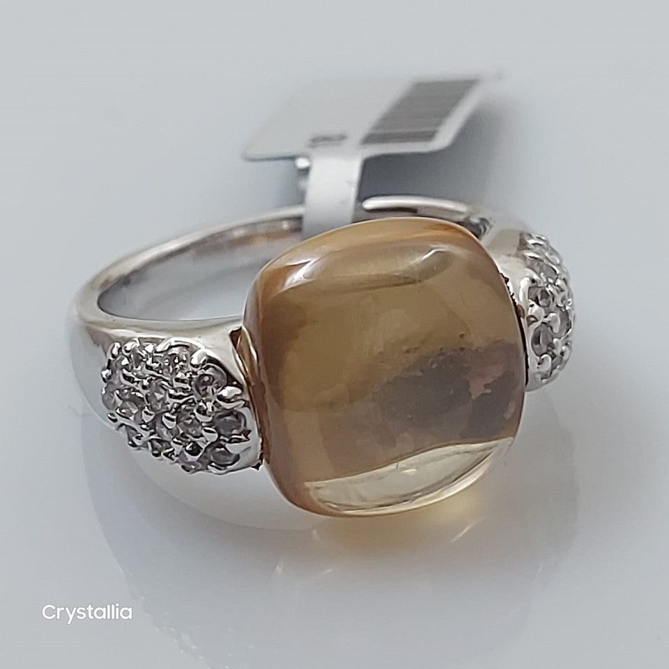 An 18 K gold plated bracelet with a large brown crystal surrounded by smaller clear crystals, with a silver clasp.