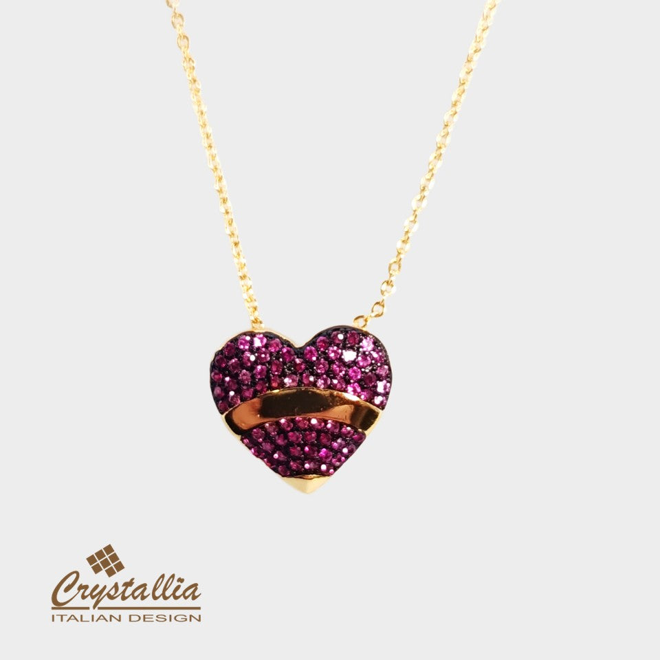 Heart-shaped necklace with pink gemstones and gold accents on a white background, featuring the Crystallia brand.