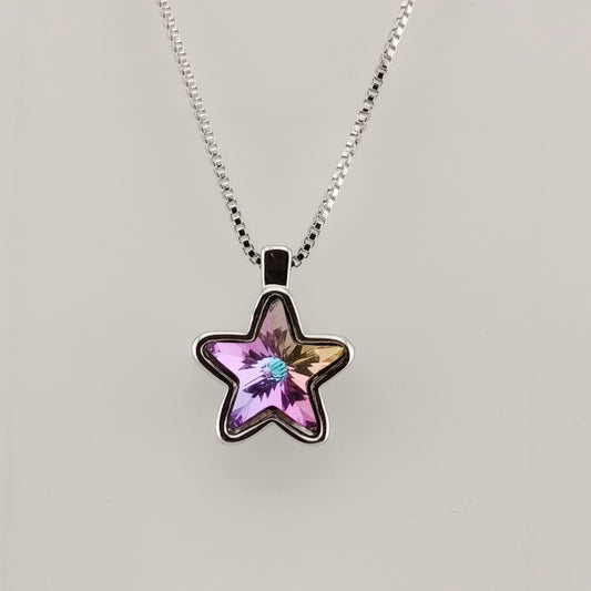 Star-shaped pendant necklace with a pink gemstone on a light gray background